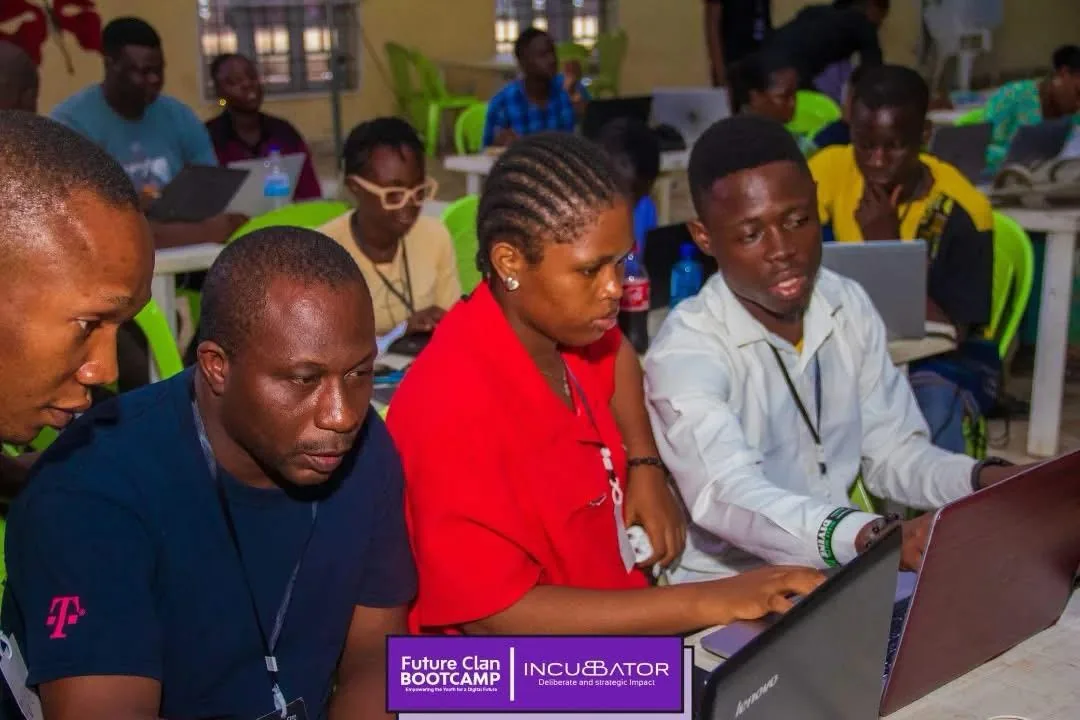Skill Up participants working together on laptops