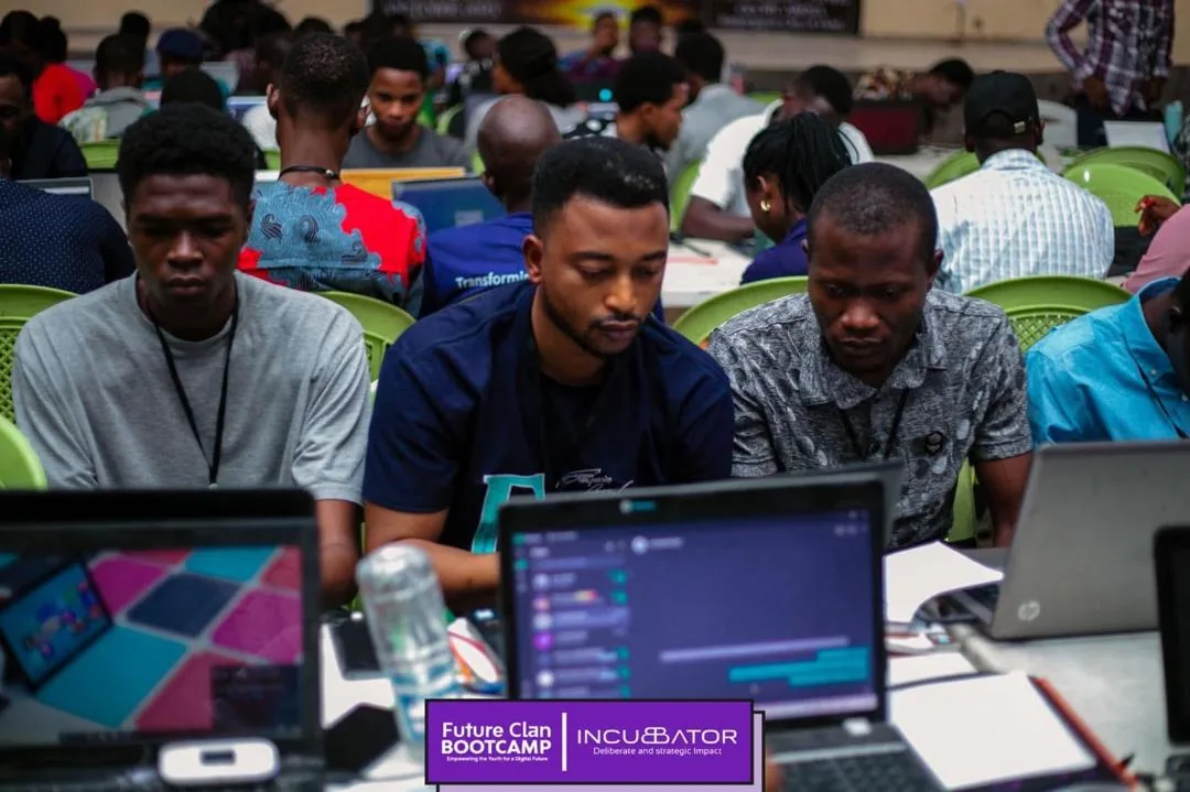 Fellows practicing technology skills with laptops