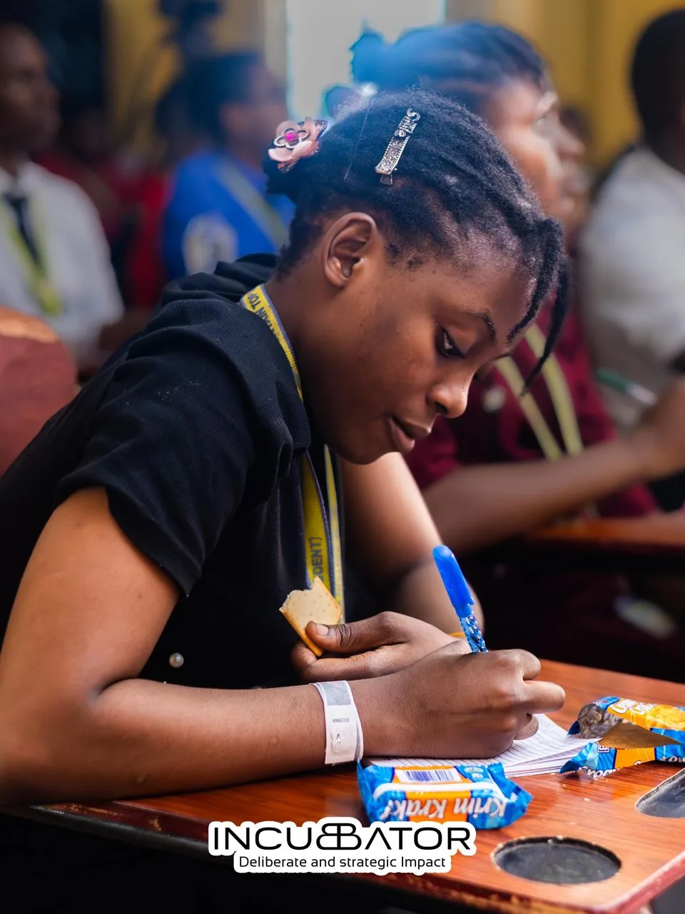 NYSC corps member taking notes during a digital skills class