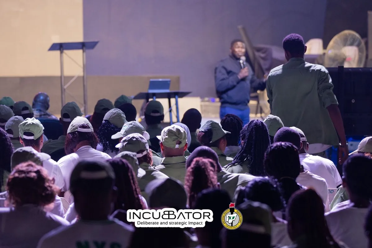 Facilitator speaking to corps members during orientation